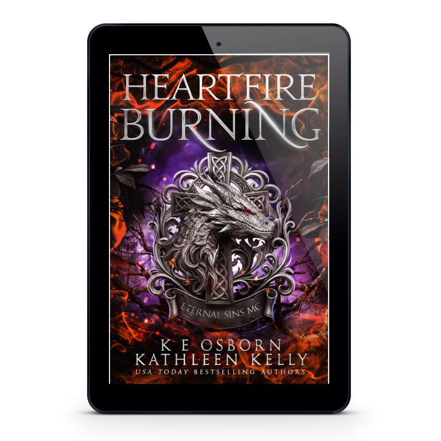 A tablet device centered on a light gray background, displaying the book cover for 'Heartfire Burning' by K.E.