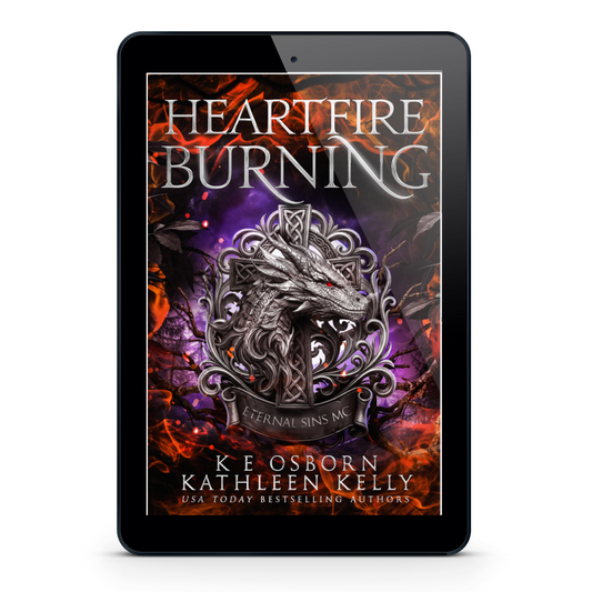 A tablet device centered on a light gray background, displaying the book cover for 'Heartfire Burning' by K.E.